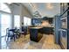Bright kitchen featuring dark cabinets, a stylish island, and modern stainless-steel appliances at 614 Ravenglen Dr, Las Vegas, NV 89123