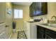 A laundry room with cabinets, a laundry sink, and a washer and dryer at 614 Ravenglen Dr, Las Vegas, NV 89123