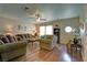 Cozy living room with hardwood floors, a ceiling fan, and comfortable seating arrangement at 614 Ravenglen Dr, Las Vegas, NV 89123