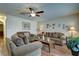 Warm living room featuring hardwood floors, ceiling fan, and a comfortable seating area with natural light at 614 Ravenglen Dr, Las Vegas, NV 89123