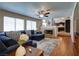 Inviting living room with a stone fireplace, large windows, and a cozy sectional sofa at 614 Ravenglen Dr, Las Vegas, NV 89123