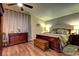 Relaxing main bedroom with hardwood floors, ceiling fan, and a comfortable bed and dresser at 614 Ravenglen Dr, Las Vegas, NV 89123