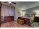 Relaxing main bedroom with hardwood floors, ceiling fan, and a comfortable bed and dresser at 614 Ravenglen Dr, Las Vegas, NV 89123