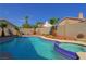 Sparkling swimming pool with an attached hot tub and lush landscaping in backyard at 614 Ravenglen Dr, Las Vegas, NV 89123