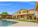 A large house with a backyard, swimming pool, patio area, covered patio, and green lawn at 6335 Iginlas Goal Ave, Las Vegas, NV 89131