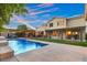 Large backyard with outdoor seating areas, pool, lush greenery, and stunning architectural home design at 6335 Iginlas Goal Ave, Las Vegas, NV 89131