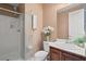 Bright bathroom featuring a glass shower, white cabinetry, and a neutral color scheme at 6335 Iginlas Goal Ave, Las Vegas, NV 89131