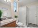 Bathroom featuring shower stall, granite countertop, wood-look floors, and a decorative mirror with sign at 6335 Iginlas Goal Ave, Las Vegas, NV 89131
