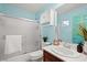 Bright bathroom featuring a shower-tub combination, vanity with plants, and medicine cabinet above the toilet at 6335 Iginlas Goal Ave, Las Vegas, NV 89131