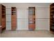 Walk-in closet with wood shelves and chrome rods for hanging clothes at 6335 Iginlas Goal Ave, Las Vegas, NV 89131