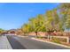 Quarter Horse Estates II entry with beautiful landscaping and wide streets on a sunny day at 6335 Iginlas Goal Ave, Las Vegas, NV 89131