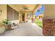 Stone pillars support a covered patio, complete with a fan, seating, and hanging plants at 6335 Iginlas Goal Ave, Las Vegas, NV 89131