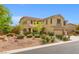 Attractive home featuring a well-maintained yard with landscaping and a three car garage at 6335 Iginlas Goal Ave, Las Vegas, NV 89131