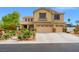 Charming two-story home with a three car garage, beautiful landscaping, and a well-maintained lawn at 6335 Iginlas Goal Ave, Las Vegas, NV 89131