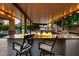 Outdoor bar with a granite countertop, fire feature, barstool seating and overhead lighting at 6335 Iginlas Goal Ave, Las Vegas, NV 89131