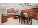 Spacious kitchen features wood cabinets, granite counters, an island, and stainless steel appliances at 6335 Iginlas Goal Ave, Las Vegas, NV 89131