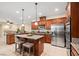 Modern kitchen with granite countertops, stainless steel appliances, central island, and ample cabinet space at 6335 Iginlas Goal Ave, Las Vegas, NV 89131