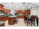 Open kitchen with stainless appliances, granite countertops, tile floors, and adjacent dining area at 6335 Iginlas Goal Ave, Las Vegas, NV 89131