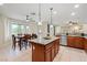 Open-concept kitchen with stainless steel appliances and a dining area by the window at 6335 Iginlas Goal Ave, Las Vegas, NV 89131