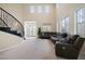 Bright living room with soaring ceilings, large windows, and comfortable sectional sofa at 6335 Iginlas Goal Ave, Las Vegas, NV 89131