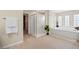 Bathroom featuring a bathtub, a shower, and many windows at 6335 Iginlas Goal Ave, Las Vegas, NV 89131