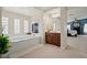 Main bathroom with a large tub, tile fireplace, and wooden cabinets at 6335 Iginlas Goal Ave, Las Vegas, NV 89131