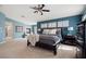 Spacious main bedroom with a ceiling fan, carpet, and a fireplace at 6335 Iginlas Goal Ave, Las Vegas, NV 89131