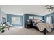 Serene main bedroom with fireplace, natural light, and calming blue walls at 6335 Iginlas Goal Ave, Las Vegas, NV 89131