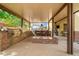 Spacious outdoor kitchen with bar seating, built-in grill, and a cozy fire feature at 6335 Iginlas Goal Ave, Las Vegas, NV 89131