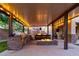 Covered outdoor kitchen area featuring built-in grill, bar seating, and fire pit at 6335 Iginlas Goal Ave, Las Vegas, NV 89131