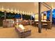 Outdoor kitchen with stone accents, built-in appliances, bar seating and a fire pit feature at 6335 Iginlas Goal Ave, Las Vegas, NV 89131