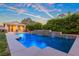 Inviting swimming pool with waterfall features surrounded by lush foliage and beautiful backyard setting at 6335 Iginlas Goal Ave, Las Vegas, NV 89131