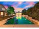 Beautiful backyard pool with waterfall features and ambient lighting, perfect for relaxation at 6335 Iginlas Goal Ave, Las Vegas, NV 89131