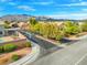 Neighborhood street view, showcasing well-maintained landscaping and curb appeal with mountain views at 6335 Iginlas Goal Ave, Las Vegas, NV 89131