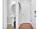 Elegant half bathroom with modern pedestal sink, stylish fixtures, and a clean design at 637 Taliput Palm Pl, Henderson, NV 89011