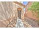 Charming home exterior featuring an arched doorway and low-maintenance landscaping at 637 Taliput Palm Pl, Henderson, NV 89011