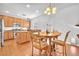 Open-concept kitchen with wood cabinets, granite countertops, island and dining table at 637 Taliput Palm Pl, Henderson, NV 89011