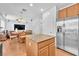 Well-lit kitchen features stainless steel appliances and an island with granite countertops at 637 Taliput Palm Pl, Henderson, NV 89011