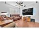 Inviting living room with hardwood floors, cozy brown furniture, and a modern entertainment center at 637 Taliput Palm Pl, Henderson, NV 89011