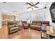 Spacious living room featuring a ceiling fan, wood floors and comfortable leather seating at 637 Taliput Palm Pl, Henderson, NV 89011