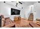 Open-concept living room features hardwood floors, staircase, and comfortable seating area at 637 Taliput Palm Pl, Henderson, NV 89011