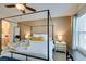 This bedroom boasts a four-poster bed, complementing decor, and an archway to the ensuite bathroom at 6576 Buster Brown Ave # 101, Las Vegas, NV 89122