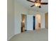 This bedroom has a ceiling fan with connecting bathroom and closet entryways at 6576 Buster Brown Ave # 101, Las Vegas, NV 89122