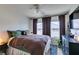 Comfortable bedroom featuring a ceiling fan, large windows, and neutral decor at 6576 Buster Brown Ave # 101, Las Vegas, NV 89122