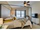 Bright bedroom features a four-poster bed, neutral tones, and natural light from a large window at 6576 Buster Brown Ave # 101, Las Vegas, NV 89122