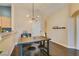 Dining area with hardwood floors, modern lighting, and open access to the living room and kitchen at 6576 Buster Brown Ave # 101, Las Vegas, NV 89122