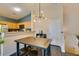 A view of the dining area with hardwood floors, modern lighting, and access to the kitchen at 6576 Buster Brown Ave # 101, Las Vegas, NV 89122