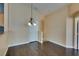Open dining area featuring wood floors and a stylish chandelier at 6576 Buster Brown Ave # 101, Las Vegas, NV 89122