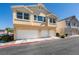 The house exterior boasts a three-car garage, lovely lawn, and a light beige facade at 6576 Buster Brown Ave # 101, Las Vegas, NV 89122