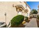 Front exterior with a well manicured lawn, pathway to a white front door and beige facade at 6576 Buster Brown Ave # 101, Las Vegas, NV 89122